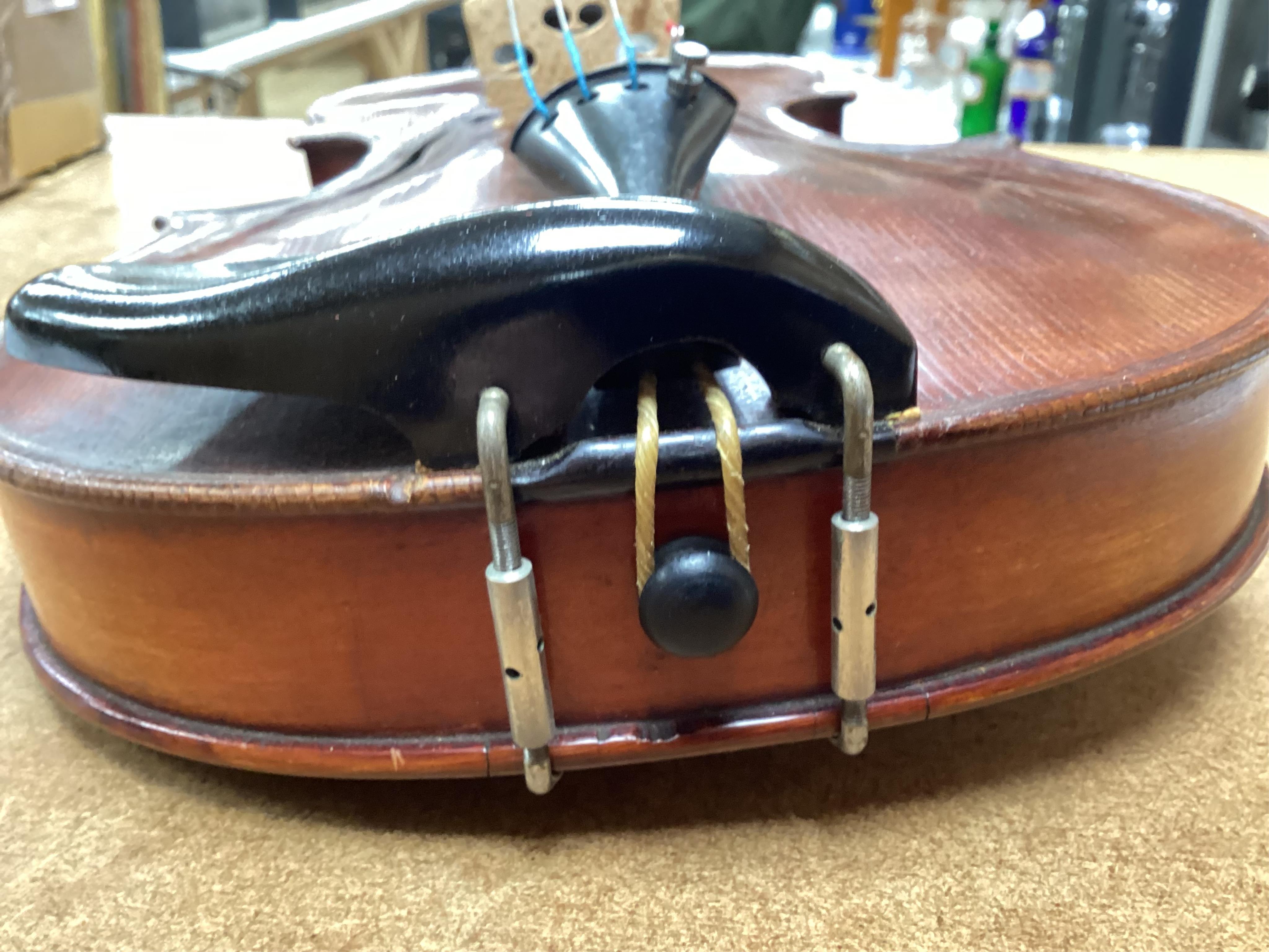 A cased late 19th century German Mittenwald violin with lion’s head scroll, and two bows, Ivory submission ref: RP2E5HT1
